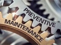 Photo on intertwined gears saying 'Preventive Maintenance'