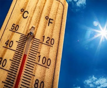 Image of an outdoor thermometer during summer heat