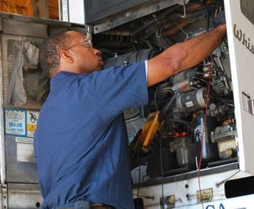 Technician working on vehicle