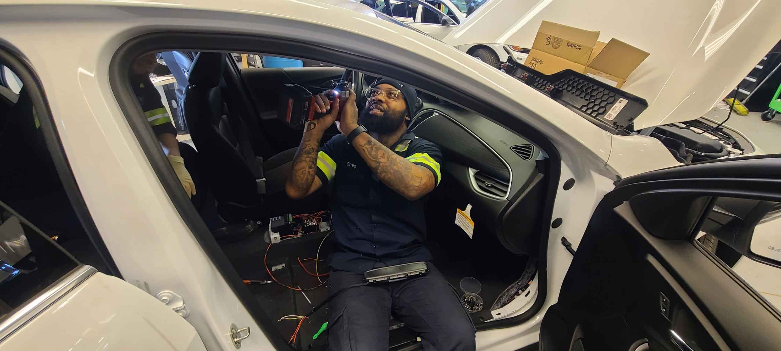 A Vector technician up fitting a police vehicle