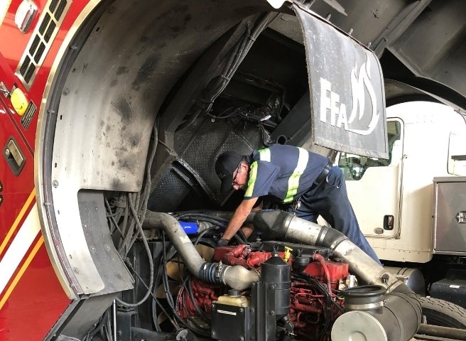 Technician Working on Fire Truck Engine