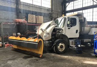 Snow plow in a garage