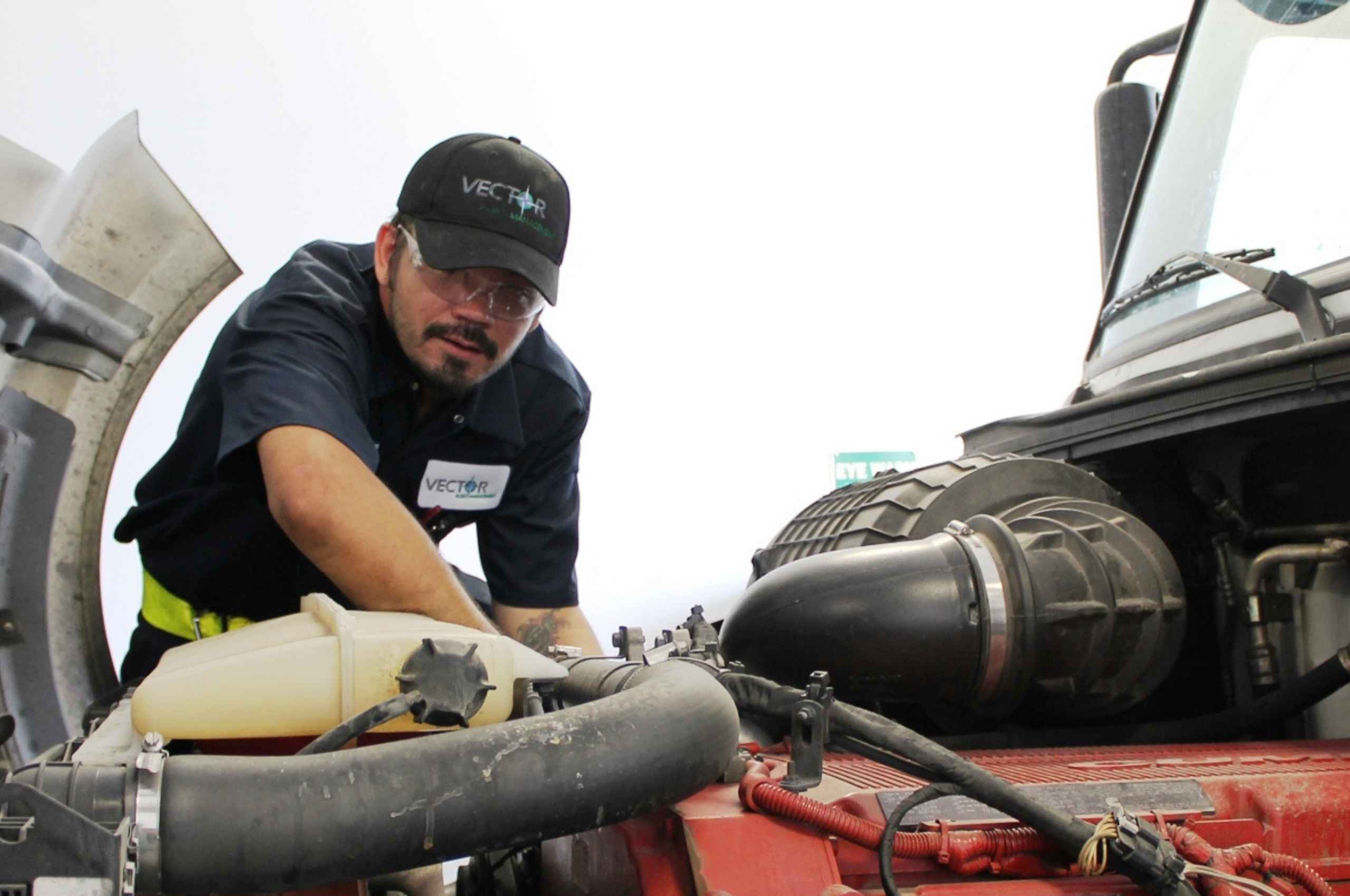 Vector Tech Working on Tractor Engine